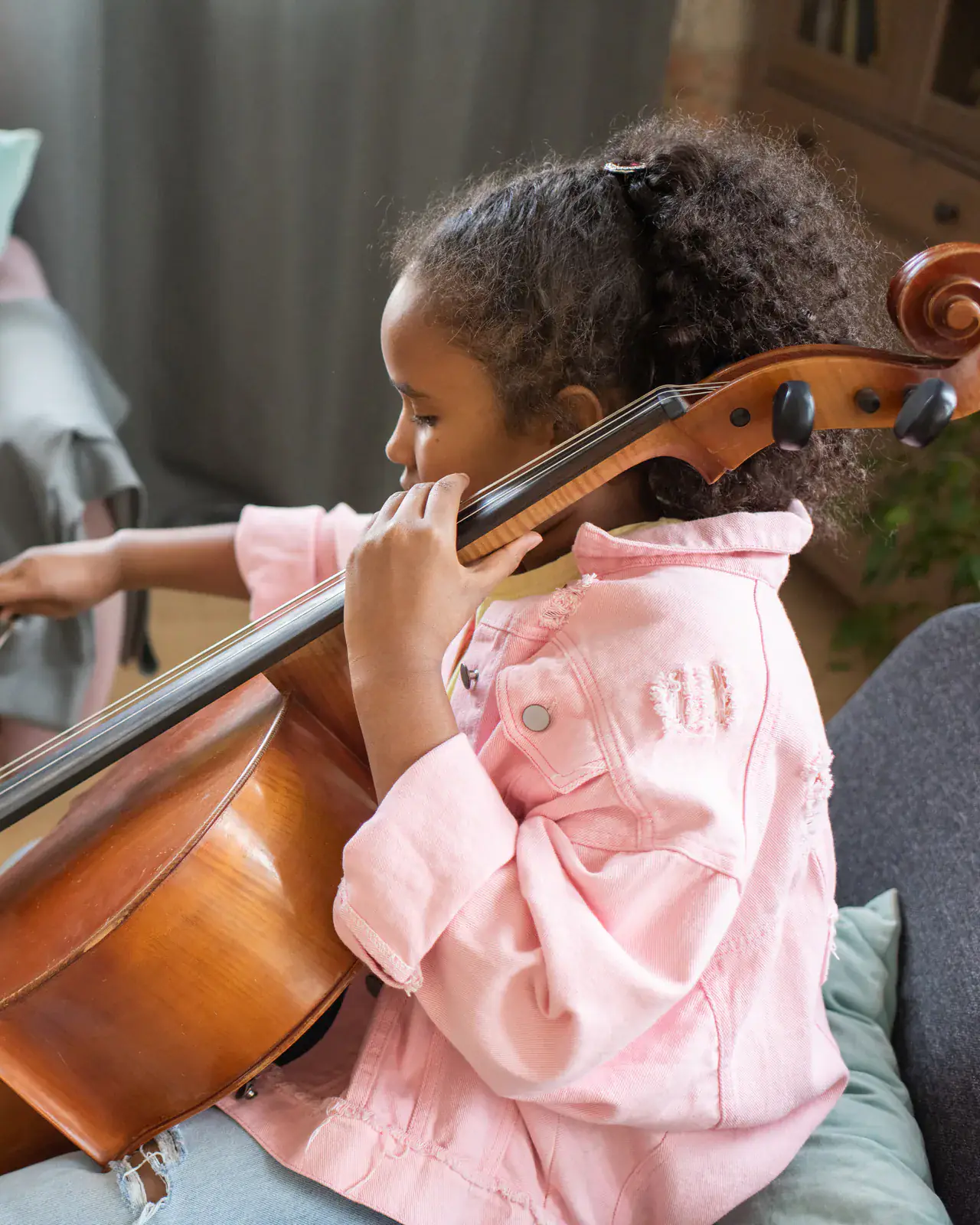 A teacher gives a cello lesson at a student's home — in-home music tuition by Concerto Music Place across Nairobi