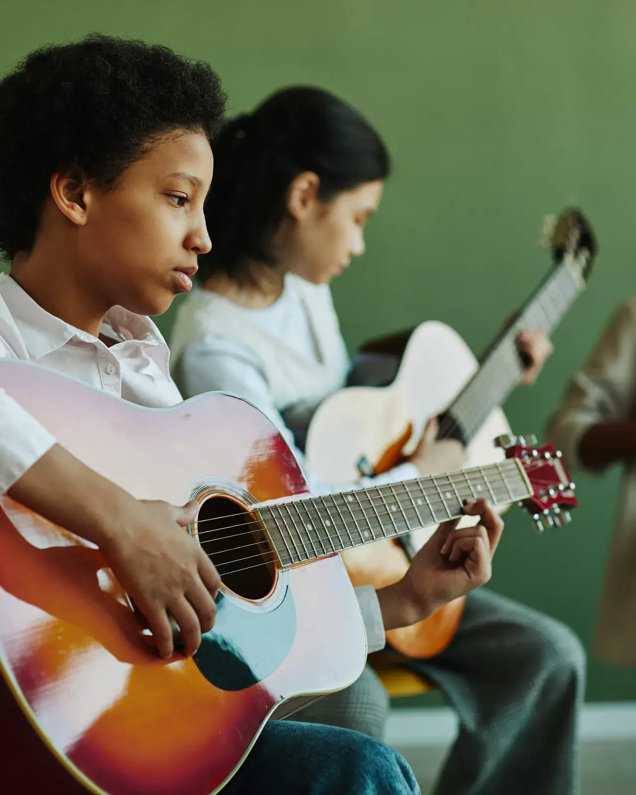 Teen students learning guitar together — small-group music classes at Concerto Music Place, Kikuyu