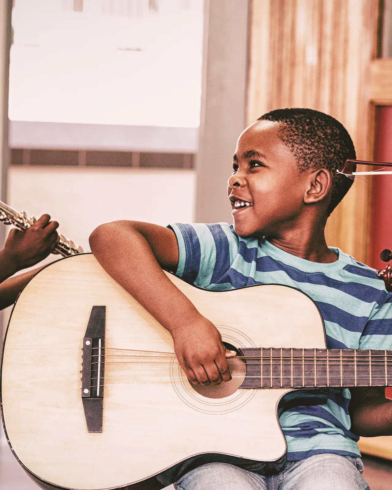 Children enthusiastically learning musical instruments — holiday music camps at Concerto Music Place