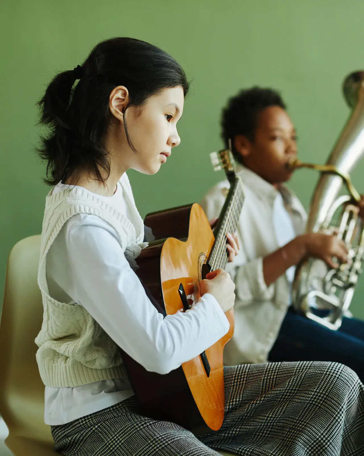 Young homeschool student practising guitar at home — daytime music lessons designed for homeschool families at Concerto Music Place