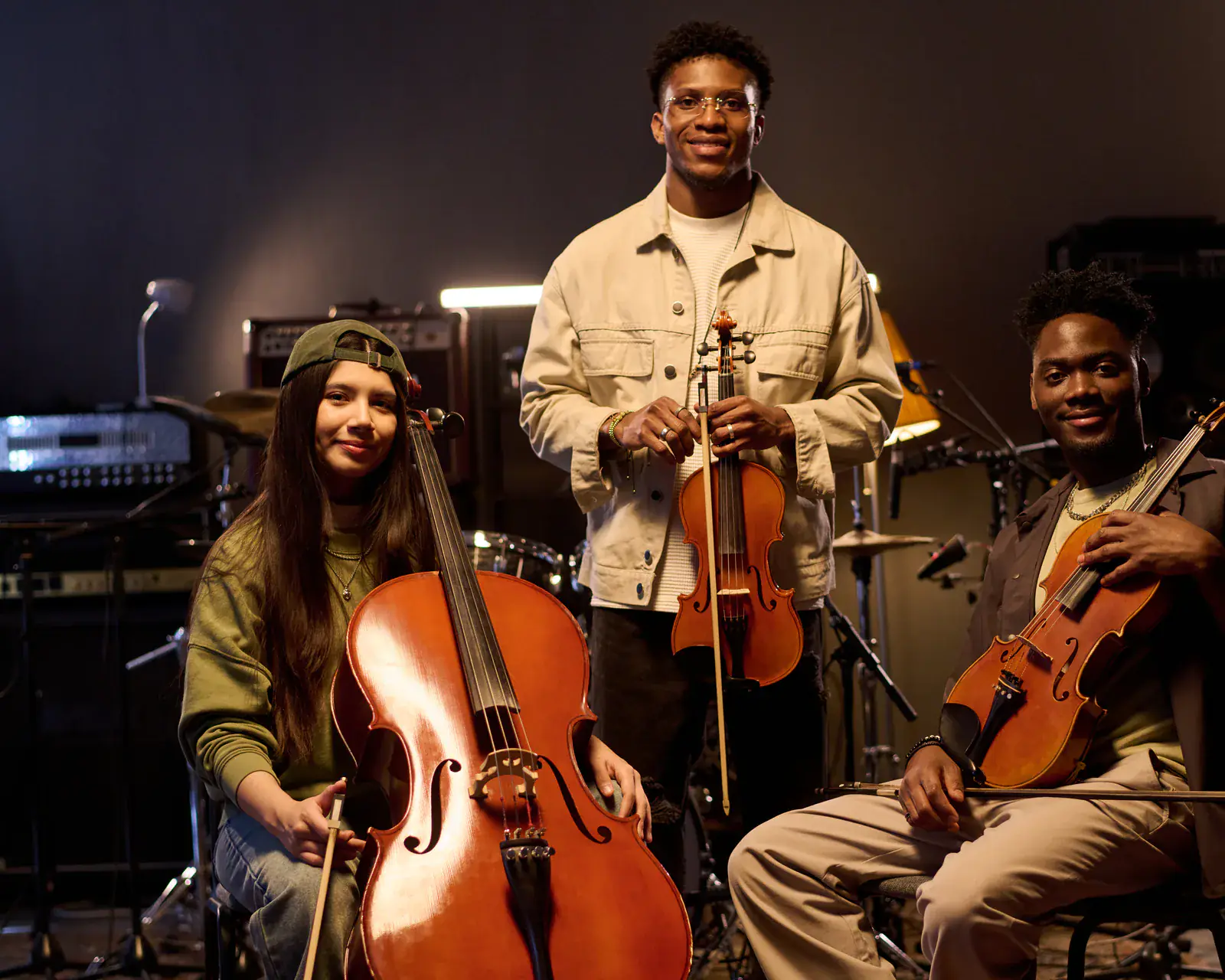 Diverse young musicians posing with string instruments — music classes at Concerto Music Place, Kenya