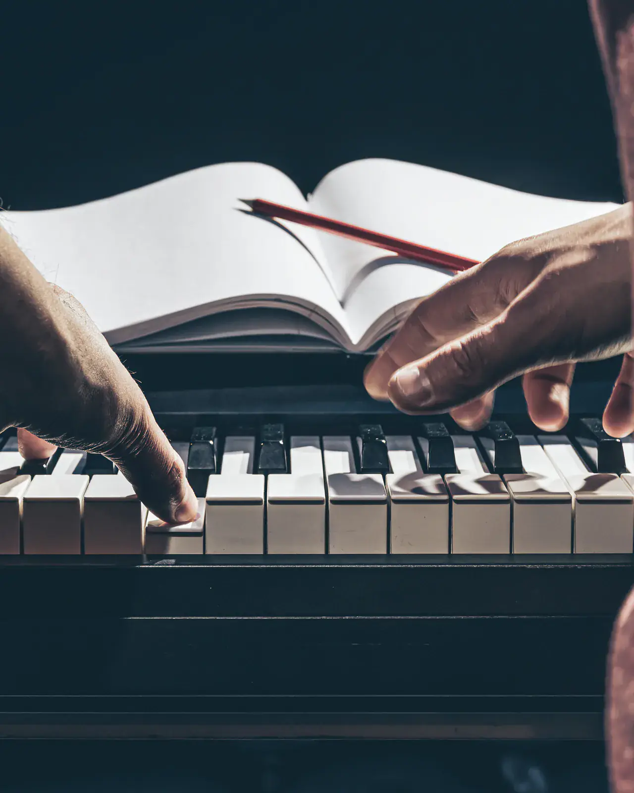 Hands at the piano with a music book — in-home music lessons in Upperhill, Nairobi